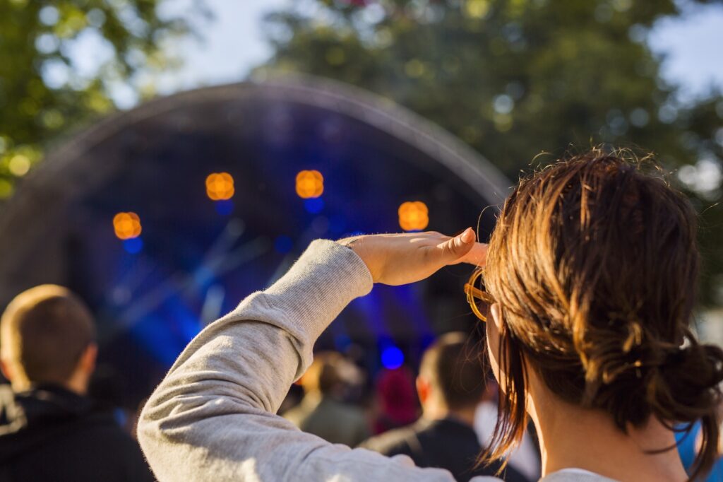 Woman watching at stage during festival