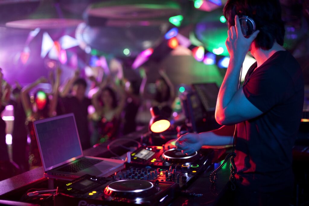 Chinese DJ doing record scratching in nightclub