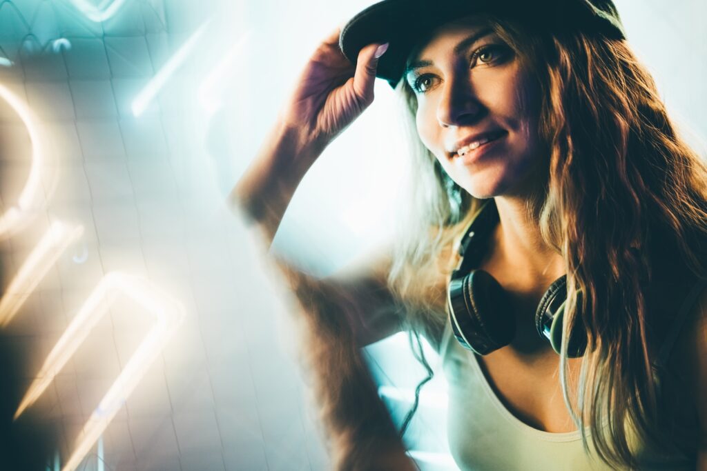 Hip-hop girl in cap in neon light. Fashion portrait of modern young woman in cap.